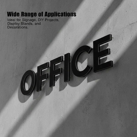 Black office sign letters mounted on a concrete wall with diagonal shadows.