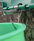 Top Shelf Maple Syrup Bucket Kit Includes Three Food Grade Sugar Containers Stainless Taps close-up of hook and tap on green pail.