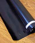 Rock Solid.006 Mil Polyethylene Moisture Vapor Barrier Roll For Laminate Engineered Hardwood Floors 100 Square Feet, flat black roll on wood floor.
