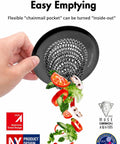Zero Hassle Kitchen Sink Drain Strainer Featuring A Patent Flip Bottom Design And Sleek Black Chain Mesh Basket with food scraps falling.