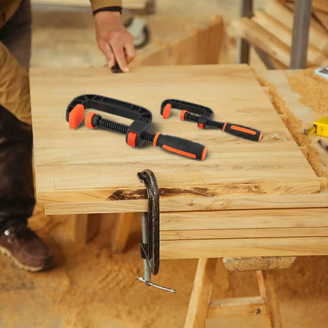 Two Piece Quick Release G Clamps Set For Woodworking With Plastic Jaw Bar Design Easy Trigger Mechanism on wooden workbench.