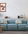 Framed palm tree artwork hangs above a modern blue sofa in a living room.