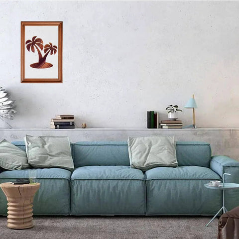 Framed palm tree artwork hangs above a modern blue sofa in a living room.