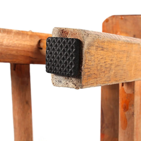 48 Pack Black Rubber Floor Protectors Self-Adhesive Non-Slip Pads applied on wooden furniture leg.
