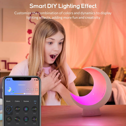 Girl amazed by Super Handy Cordless Moon Lamp For Your Bedside Table With Alexa Voice Control And App Connectivity, glowing pink.