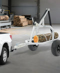 Heavy Duty Log Trailer For Farm Use, Two Wheel Utility Trailer Built Tough With Sturdy Frame And Chain attached to truck