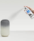 Person spraying vase with 2X Ultra Cover Satin Granite Spray Paint For Interior And Exterior Surfaces That Sticks To Wood Plastic Metal