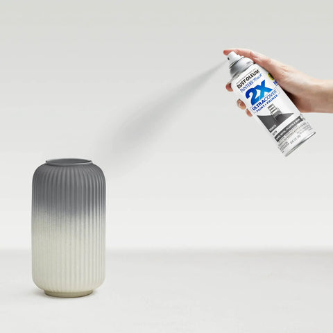 Person spraying vase with 2X Ultra Cover Satin Granite Spray Paint For Interior And Exterior Surfaces That Sticks To Wood Plastic Metal