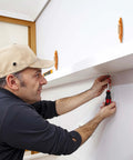 Person using 2 Pack Magnetic Stud Finders, Heavy Hitter Nail Head Locator for Drywall to mount a shelf