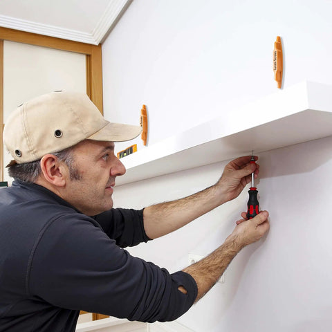 Person using 2 Pack Magnetic Stud Finders, Heavy Hitter Nail Head Locator for Drywall to mount a shelf