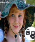 Young girl in camo hat with Forty Piece Cord Locks Set For Drawstrings Black Plastic Toggle Stoppers on chin strap