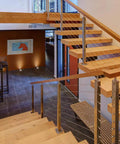 Modern indoor staircase with wood steps and metal railings using 1/8 Inch T316 Stainless Steel Wire Rope Cable 300 Ft For Deck Railing Kit Aircraft Grade 7x7 Construction Outdoor Coastal Ready Anti Oxidation And Corrosion Resistant DIY Balustrades With Cutter Included