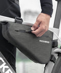 Person attaching 2.5L Triangle Bike Frame Bag Waterproof Under Frame Storage For Bikepacking Trail Ready Large Capacity Pouch.