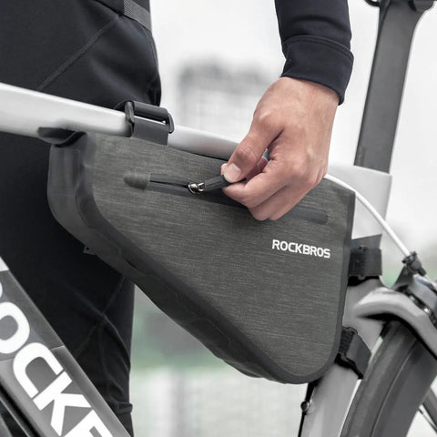 Person attaching 2.5L Triangle Bike Frame Bag Waterproof Under Frame Storage For Bikepacking Trail Ready Large Capacity Pouch.