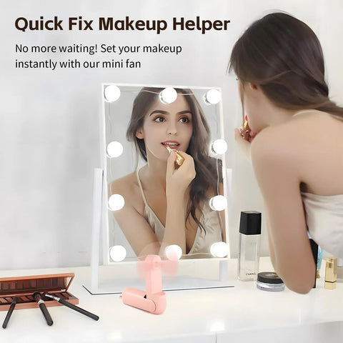 Portable Mini Handheld Fan With USB Rechargeable Power Bank And Built In LED Flashlight Foldable Pocket Cooling Fan on vanity table
