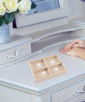 Beige Velvet Jewelry Display Tray With Four Grids And Sturdy Wooden Lid For Ring Bracelet Earring Storage Stackable Vanity Organizer on a dresser.