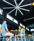 96 Inch Heavy Duty Industrial Ceiling Fan In Slick Silver With Six Speed Remote Control For Garage Barn Warehouse And Great Room, indoor setting.