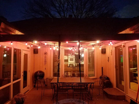 Clear S14 LED String Light Bulbs 2W Plastic Dimmable Replacement Bulbs For Outdoor Patio String Lights With E26 Base Pack Of 25 Ideal For Pergolas Decks And Outdoor Parties Weather Resistant And Safe illuminating a patio at night
