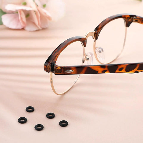 Six Piece Eyeglass Repair Kit With Glasses Temple Grips And Silicone Hinge Tighteners To Give Your Specs A Solid No Sweat Grip Plus Compact Screwdrivers For A Breeze Quick Fix That Works Like A Charm All Day, featuring tortoiseshell glasses and black silicone grips.