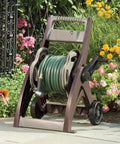 175 Ft Hose Reel Cart With Taupe Finish, Manual Operation, on wheels with garden flowers background
