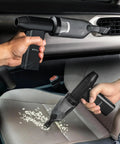 Person using 3 In 1 Cordless Air Duster And Mini Vacuum With LED Light USB C Rechargeable 180000 RPM 5 Speeds in a car