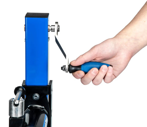 Hand operating the hand crank on a Heavy Duty Mechanical Lift Bicycle Repair Stand For E Bikes Cargo Bikes And MTB Rigs With 120 Lb Capacity