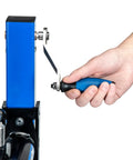 Close-up of hand operating the hand crank on Mechanical Lift Bicycle Repair Stand For E Bikes, Cargo Bikes, And MTB, 120 Lb Capacity.