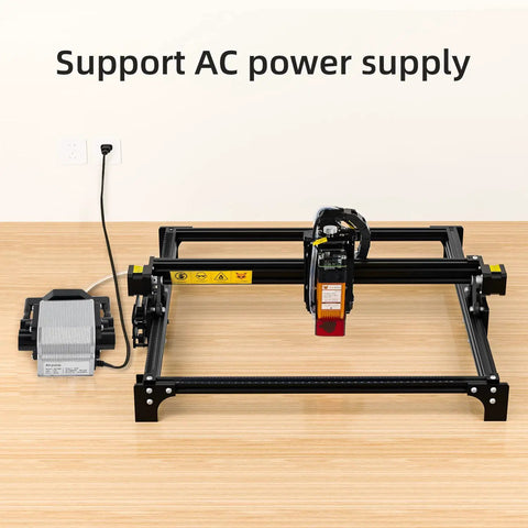 AP30A Portable Air Assist Pump 0 To 30 Liters Per Minute Adjustable Airflow For CNC Engraving Machines With Six And A Half Foot Hose And 4 Mm Inner Diameter Tube next to CNC machine, powered by AC outlet.