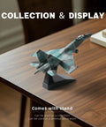 One Hundredth Scale SU-35S Fighter Jet Quick Build Model Kit With Stand on wooden table, displayed as desktop decoration