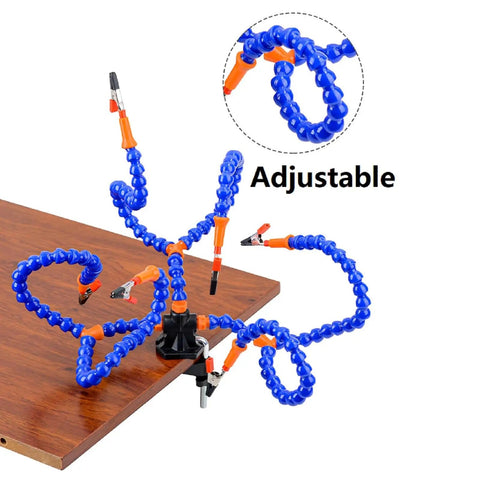 Six Flexible Arm Helping Hands Soldering Station With Silicon Clip Tips attached to a wooden table corner, showcasing adjustability.