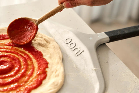 Ooni 12-inch aluminum pizza peel with black handle.