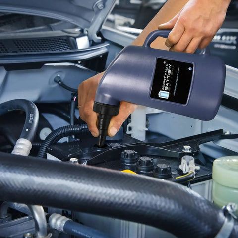 Auto Shut Off Battery Filler Jug For Golf Carts And Deep Cycle Batteries being used with fast flow valve in car engine bay.