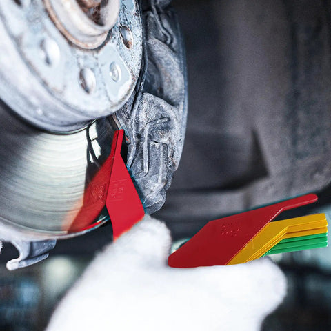 Smooth Operator 8 Piece Brake Pad Thickness Gauge Set showing red blade measuring brake pad wear on a disc.