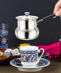Turkish Coffee Pot Stainless Steel On The Go Travel Brew Kit 1080ml Small Saucepan Portable Butter Melter And Milk Warmer For Coffee Lovers Perfect For Travel Camping Dorms Office Mornings used to pour coffee into a cup.