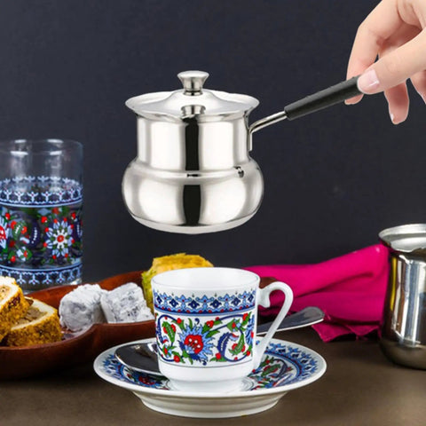 Turkish Coffee Pot Stainless Steel On The Go Travel Brew Kit 1080ml Small Saucepan Portable Butter Melter And Milk Warmer For Coffee Lovers Perfect For Travel Camping Dorms Office Mornings used to pour coffee into a cup.