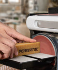 Hand using Two Pack Eight And A Half Inch Abrasive Cleaning Stick For Sanding Belts And Discs Natural Rubber Eraser on disc sander