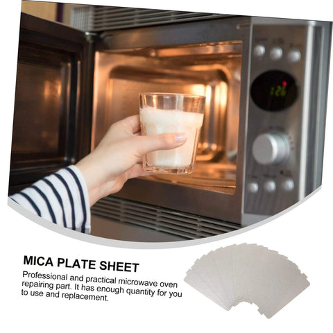 Open microwave with hand holding a cup, displaying 12 Piece Mica Plate Sheet Set For Microwave Waveguide Cover Replacement Parts Heat Resistant