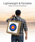 Person carrying 20 Inch Straw Archery Target For Backyard Practice, 2.4 Inch Thick High-Density Target with handle in field.