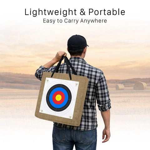 Person carrying 20 Inch Straw Archery Target For Backyard Practice, 2.4 Inch Thick High-Density Target with handle in field.
