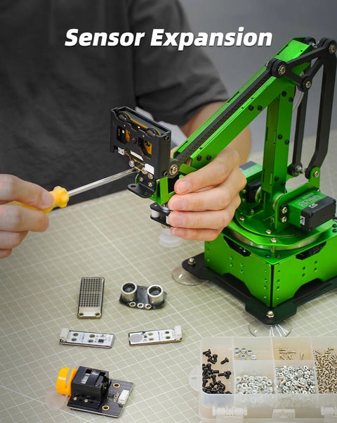 LewanSoul Robotic Arm Kit, side view with green frame; screwdriver in use, several circuit boards and hardware on table.