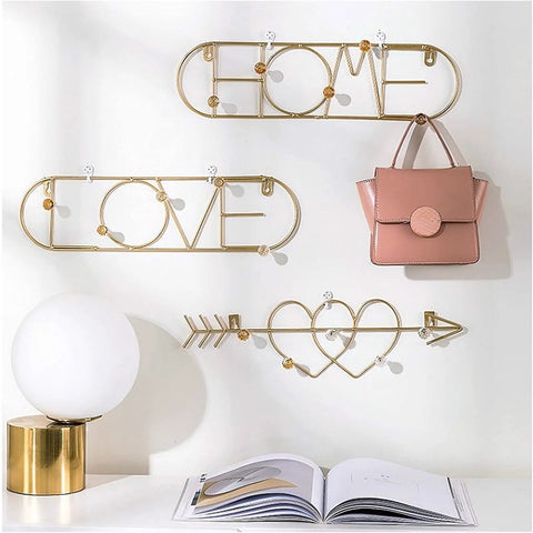 Sleek Wall Mounted Coat Rack Featuring Heavy Duty Gold Metal Hooks To Keep Your Daily Gear Locked Down While Bringing Major Street Style To Any Hallway Entryway Or Office Setup That Never Misses with pink bag and lamp.