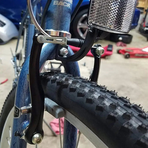 Close-up of V Brakes For Bikes Front And Rear V Brake Set on a mountain bike, featuring beefy aluminum arms and 110mm arch.