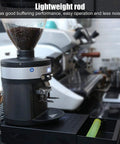 No Hassle Stainless Steel Coffee Knock Box Featuring Quick Release Drawer And Shock Absorbing Buffer For Zero Splash Clean Up and Pro Level Espresso Tamping Setup on countertop with coffee grinder.