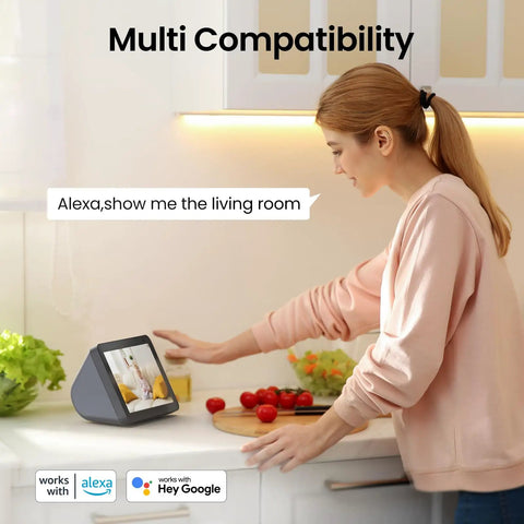 Woman using smart display to view 2K Indoor Security Camera With 360 Degree Pan Tilt, 2.4Ghz WiFi footage, multitasking in kitchen
