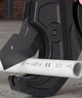 Close-up of a Ratcheting PVC CPVC Pipe Cutter with Wide Jaw Opening and Anti Fatigue Grip cutting a white pipe