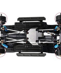 Bottom view of Traxxas TRX-4 with Beefy Heavy Duty Brass Portal Weight Hangers, showing steering knuckle caps and drive housings.