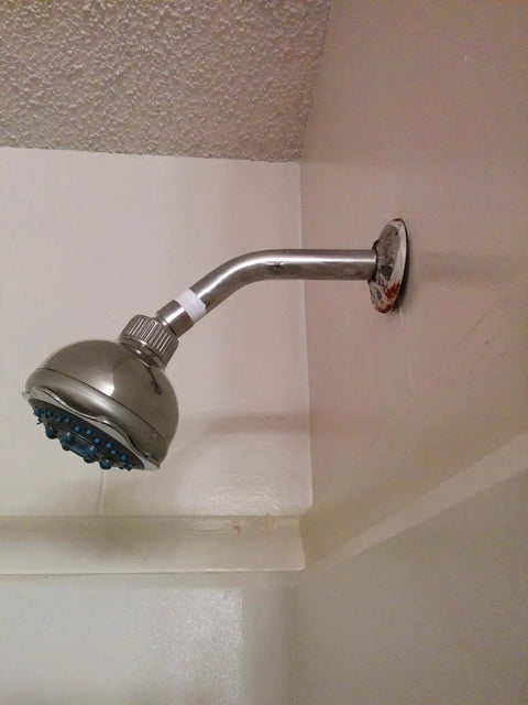Installed showerhead with visible Pro Grade PTFE Thread Seal Tape For Plumbers 1 Inch By 520 Inch Go To Leak Proof Sealant.