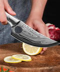 Beast Meat Cleaver And All Purpose Kitchen Knife For Cutting Meat Bone Fruit And More With Stainless Steel Blade High Carbon Steel Build being used to slice a lemon on a wooden board