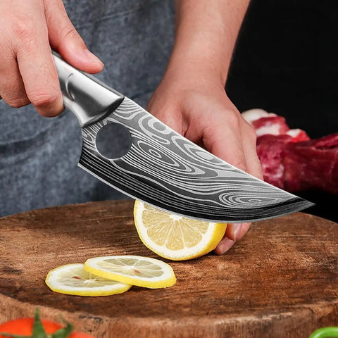 Beast Meat Cleaver And All Purpose Kitchen Knife For Cutting Meat Bone Fruit And More With Stainless Steel Blade High Carbon Steel Build being used to slice a lemon on a wooden board