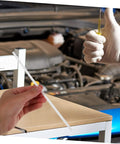 Person holding one of 10 Pcs Car Bumper Welding Rods for Quick Bumper Repairs in auto shop setting, white PP material, DIY friendly